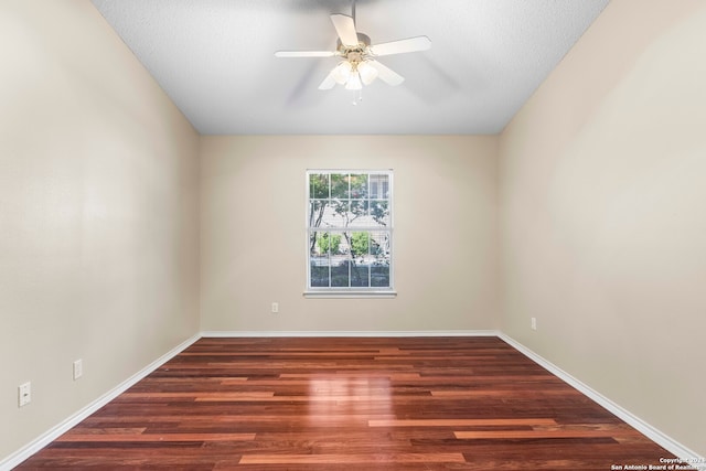 empty room featuring ceiling fan, a textured ceiling, and dark hardwood / wood-style flooring