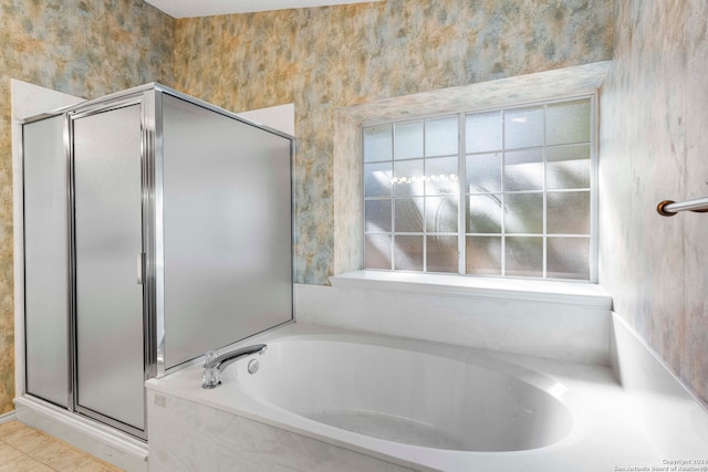 bathroom with independent shower and bath and tile patterned floors