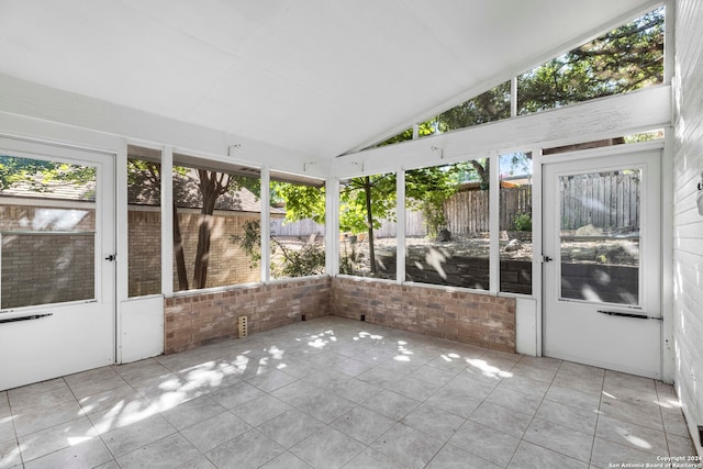 unfurnished sunroom featuring lofted ceiling