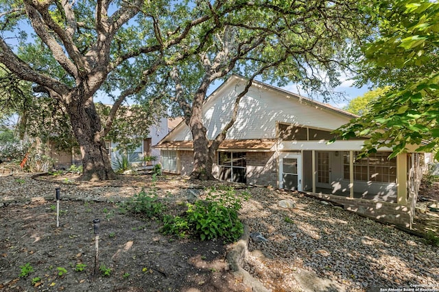 back of property with a sunroom