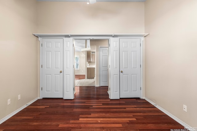 unfurnished bedroom with dark wood-type flooring