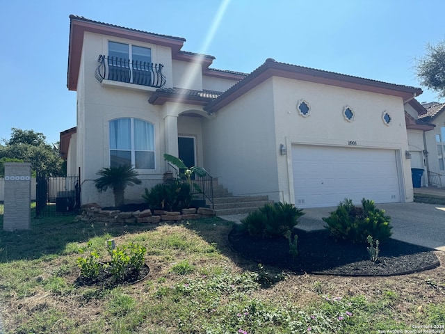 mediterranean / spanish-style home with a garage