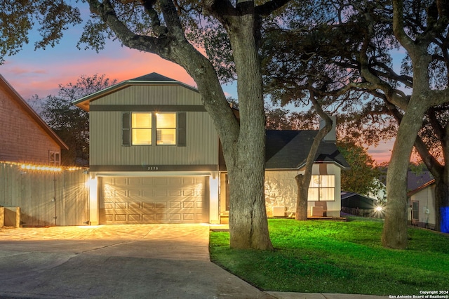 view of front of house featuring a yard and a garage