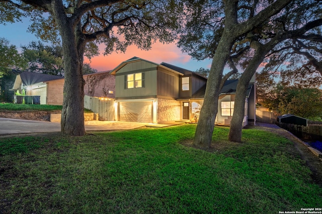 view of front of home with a yard and a garage