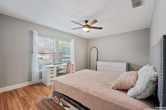 bedroom with light hardwood / wood-style floors and ceiling fan