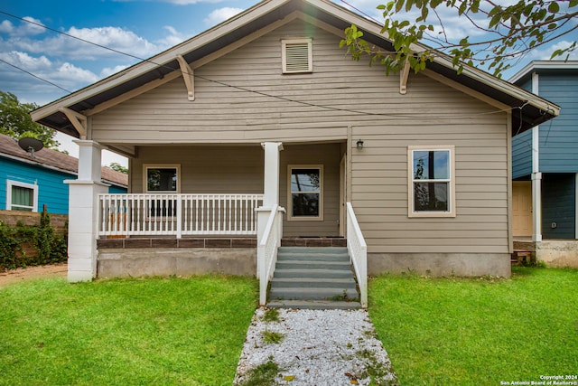 view of front of property with a front lawn and a porch