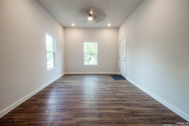 empty room featuring ceiling fan and dark hardwood / wood-style floors