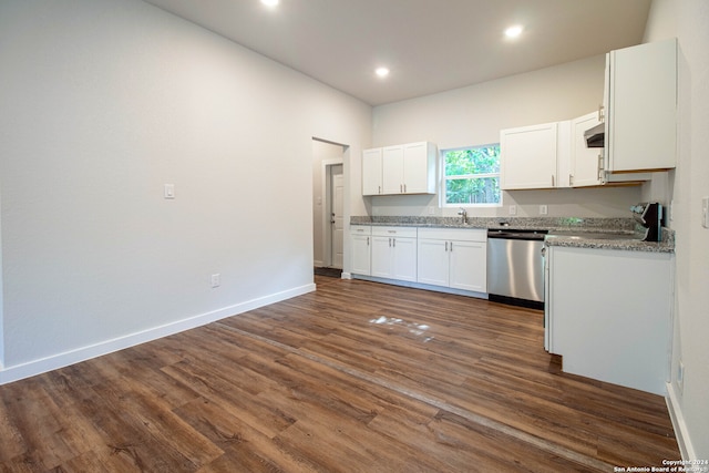 kitchen featuring white cabinetry, stainless steel dishwasher, light stone counters, and dark hardwood / wood-style floors