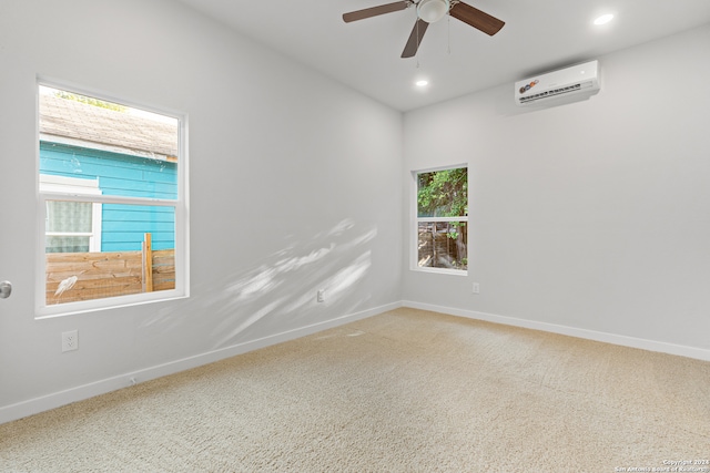 carpeted empty room with ceiling fan, a wealth of natural light, and a wall mounted air conditioner