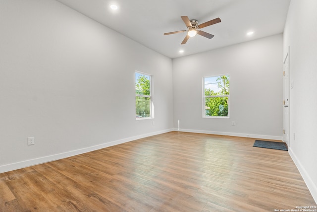 empty room with light hardwood / wood-style flooring and ceiling fan