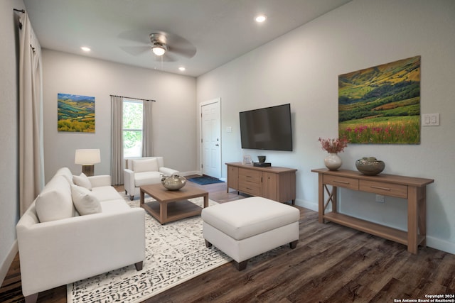 living room with dark hardwood / wood-style floors and ceiling fan