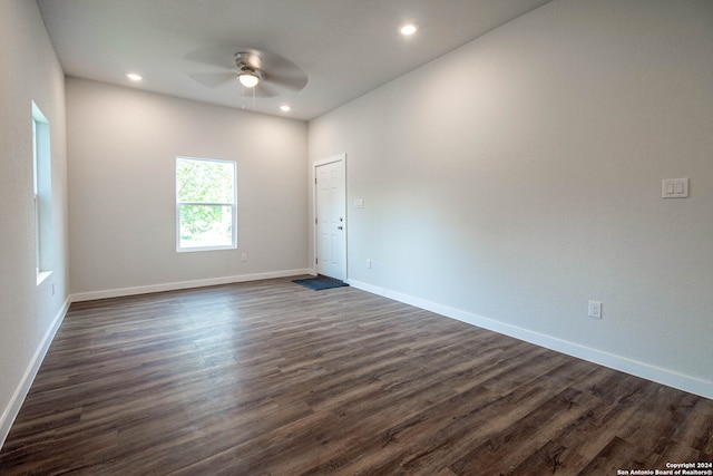 unfurnished room with dark wood-type flooring and ceiling fan