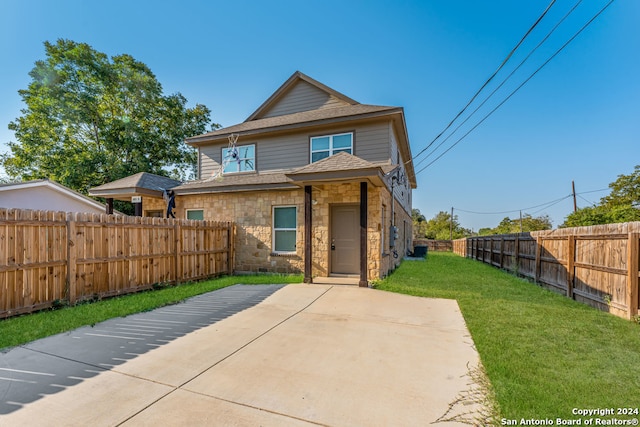 back of property featuring a patio area and a yard