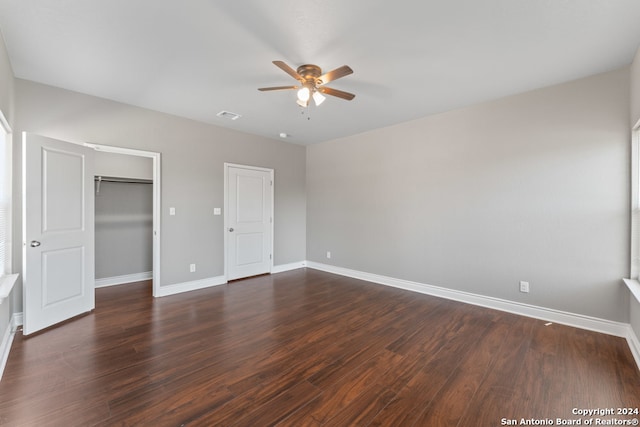 unfurnished bedroom featuring dark hardwood / wood-style floors, a closet, and ceiling fan