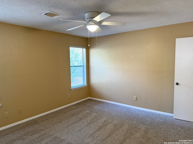 carpeted empty room featuring a textured ceiling and ceiling fan