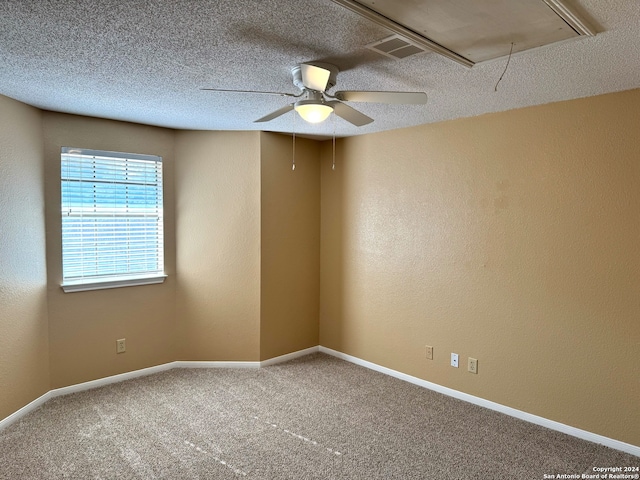 carpeted empty room with ceiling fan and a textured ceiling