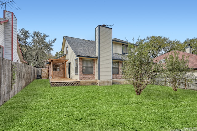 rear view of property with a lawn