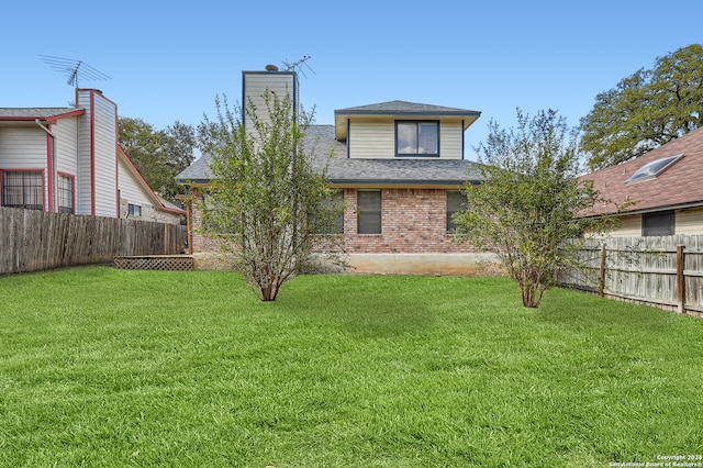 rear view of house with a lawn