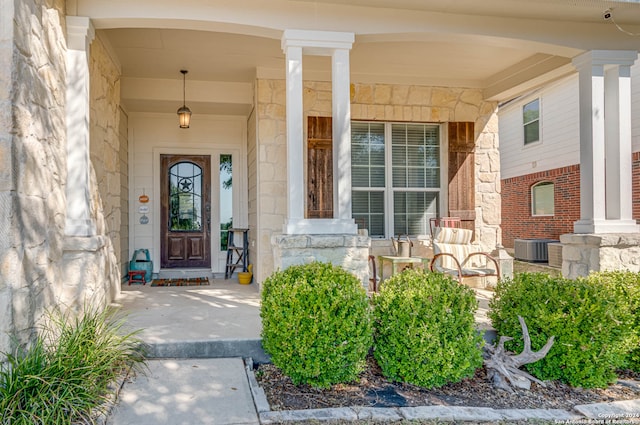 doorway to property featuring a porch and central air condition unit