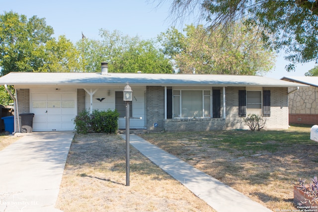 single story home featuring a garage and a porch