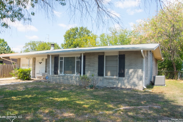 single story home with a front yard and central AC