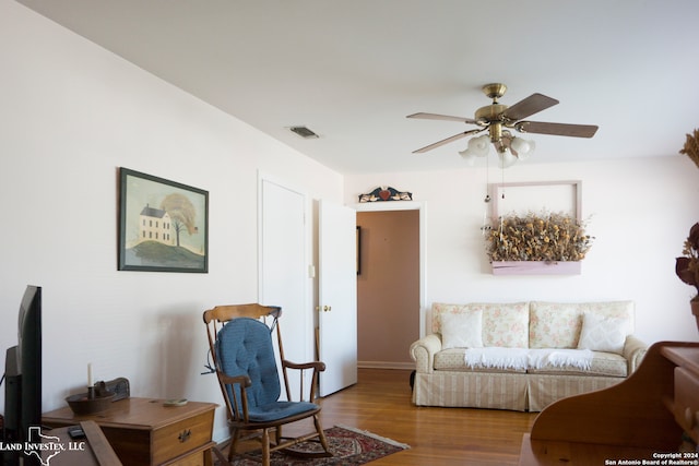 living room with hardwood / wood-style flooring and ceiling fan