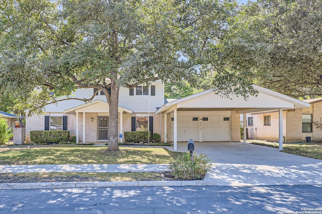 view of front of home featuring a front yard, a garage, and a carport