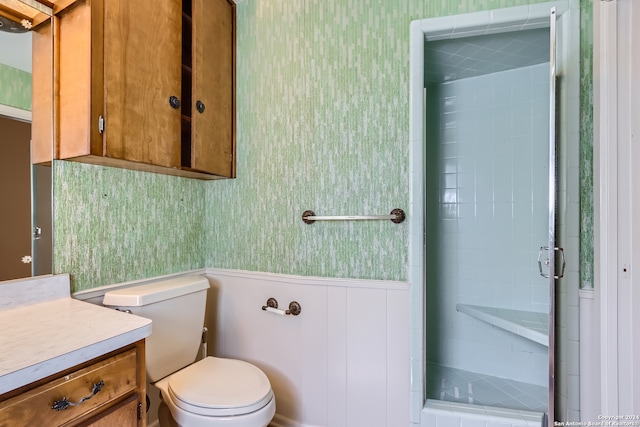 bathroom with vanity, toilet, and an enclosed shower