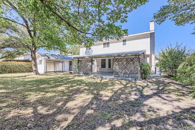 rear view of property with a yard and a patio