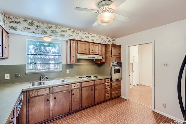 kitchen featuring ceiling fan, tasteful backsplash, appliances with stainless steel finishes, and sink