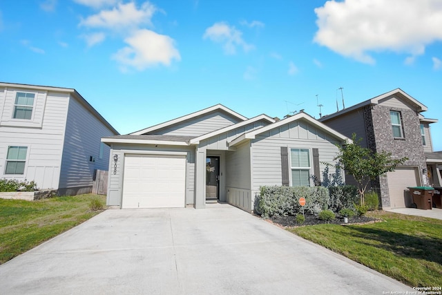 view of front of home with a garage and a front lawn