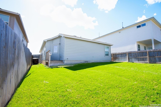 back of house with a yard and central air condition unit