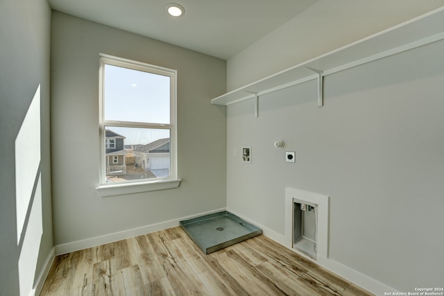 laundry area with hookup for an electric dryer, washer hookup, light wood-type flooring, and hookup for a gas dryer