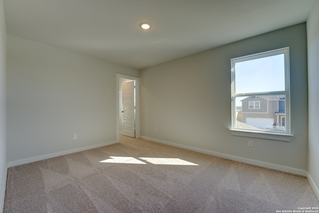 spare room with light carpet