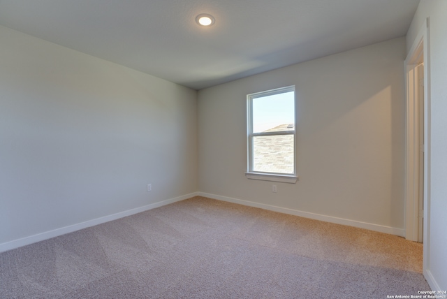 empty room featuring light carpet