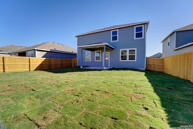 rear view of house with a lawn