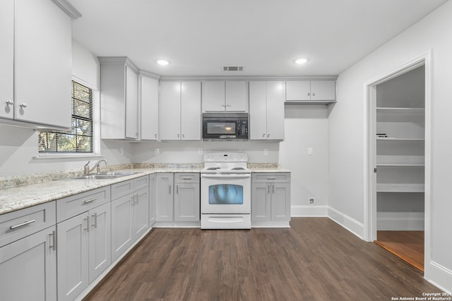 kitchen with white electric range, light stone countertops, sink, and dark hardwood / wood-style floors