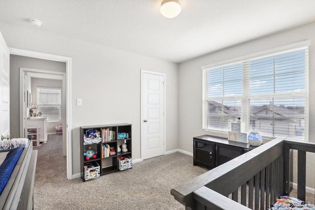 bedroom with carpet and a crib