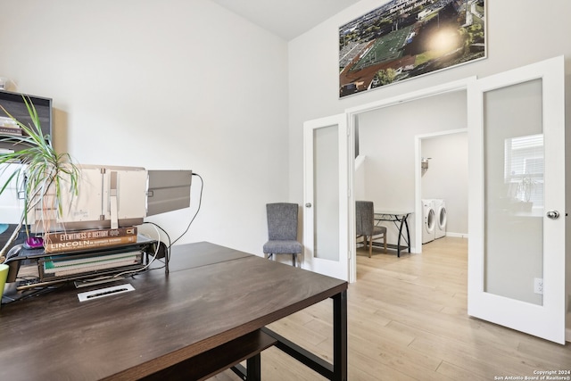 home office featuring light hardwood / wood-style floors, french doors, and washing machine and dryer