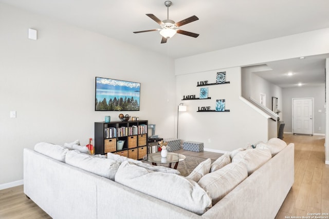 living room with ceiling fan and light hardwood / wood-style flooring