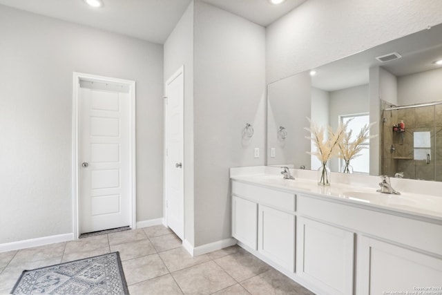 bathroom with vanity, an enclosed shower, and tile patterned flooring