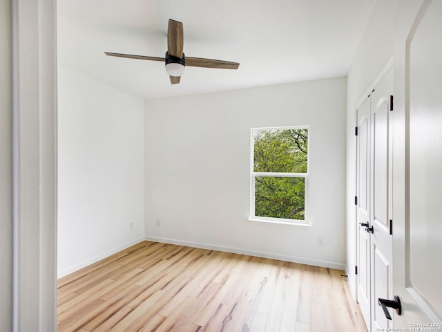 empty room with light hardwood / wood-style floors and ceiling fan