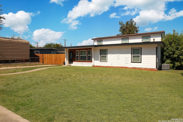 back of property featuring central AC and a lawn