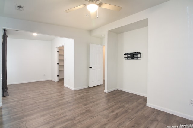 empty room featuring wood-type flooring and ceiling fan