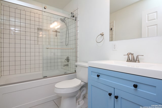 full bathroom featuring vanity, toilet, tiled shower / bath combo, and tile patterned flooring