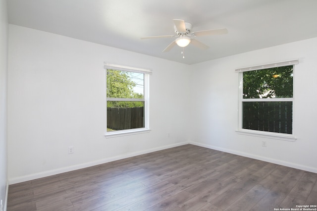 spare room with dark hardwood / wood-style floors and ceiling fan