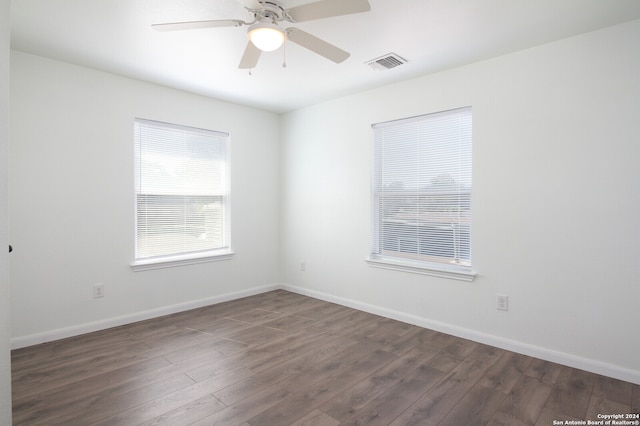 spare room featuring ceiling fan and dark hardwood / wood-style flooring