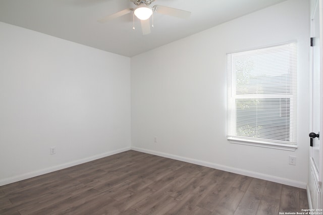 unfurnished room with ceiling fan and dark hardwood / wood-style flooring