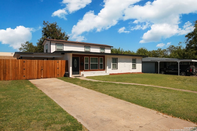 view of front of house with a front lawn and a carport