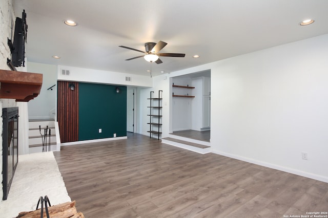 unfurnished living room with ceiling fan and wood-type flooring